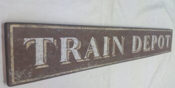 A brown painted Train Depot wood sign