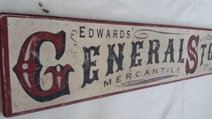 The Edwards general store sign in cream paint with red accent