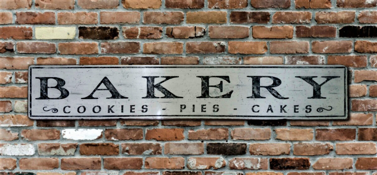 Photo of the Bakery Sign with the lettering Cookies Pies Cakes below.