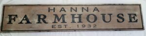 Photo of the Hanna Farmhouse sign in rustic nutmeg paint, distressed to perfection.