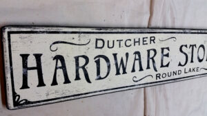 Closeup of the Dutcher Hardware Store wood Sign