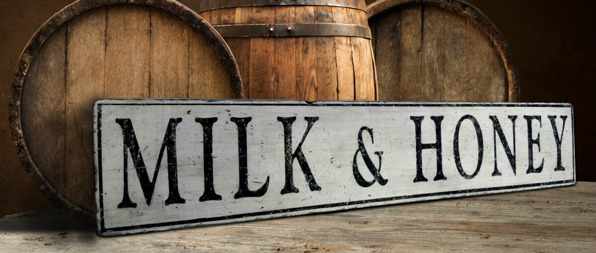 Milk and Honey wood sign on an off white antique painted board.