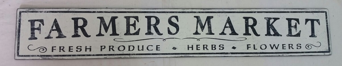 The original Farmers Market sign, with Fresh Produce Herbs Flowers lettering underneath.