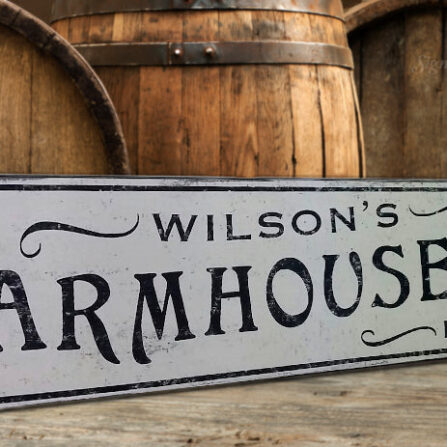 The Farmhouse Bakery Sign with a custom name, sign against barrel backdrop