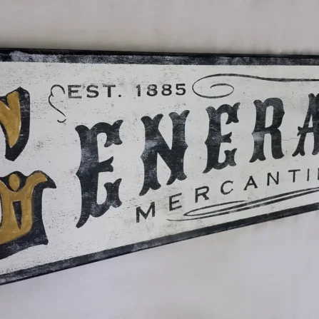 Detailed view of rustic General Store sign showcasing distressed lettering and wood texture