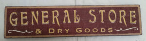Photo of the General Store and Dry Goods wood Sign in red with gold lettering