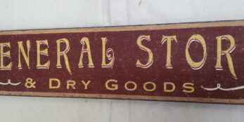 General Store Dry goods sign in Tuscan red and gold closeup photo
