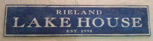 Lake House Sign example with navy background and white letters