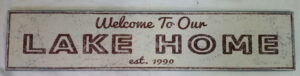 Welcome to Our Lake Home Wood Sign with cream background and brown letters