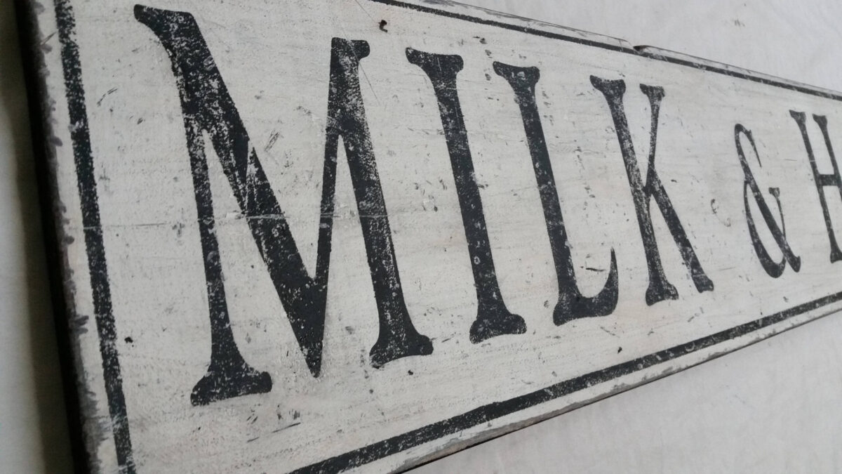 Milk and Honey sign distressing close up