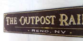 The Outpost Railroad Reno Nevada Sign in rustic brown with gold letters