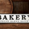Bakery Sign with Baked Fresh Daily lettering, in white and black