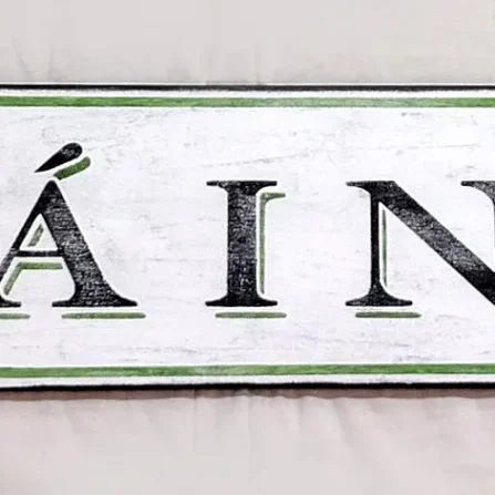 Antique style Slainte sign with distressed white finish and black letters