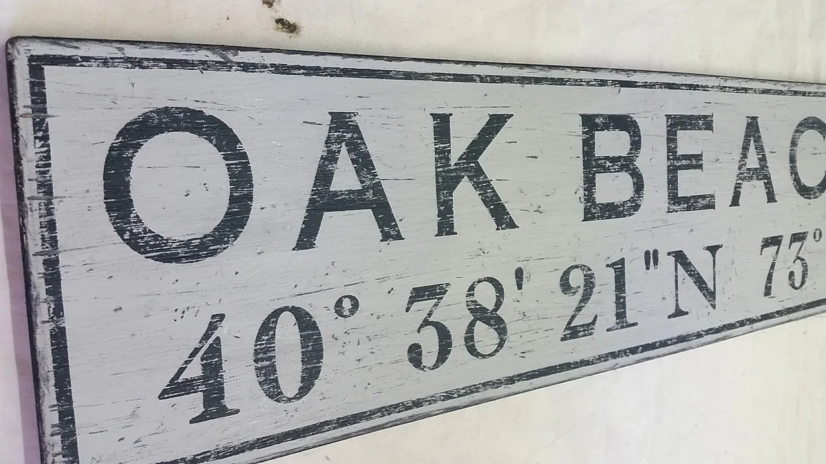 Closeup of personalized wood sign with city name and coordinates