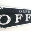 Closeup view of off-white letters and decorative design on an office sign