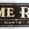 Vintage-style "Game Room" sign with black distressed background and gold lettering