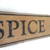 Closeup view of the antique style sign showcasing black letters on a rich nutmeg background.