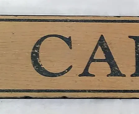 Antique style sign with a rich nutmeg background and black letters, designed for marking a spice cabinet in the kitchen.