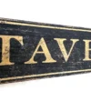 Closeup view of antique gold letters on a rustic tavern sign
